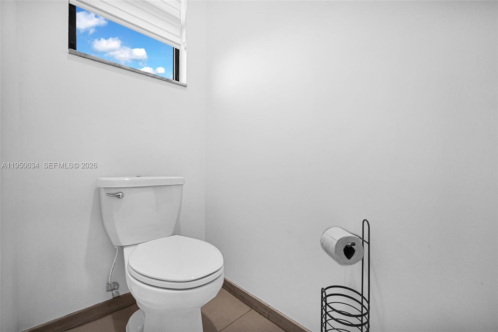 10966 West 35th Way Hialeah, FL 33018 - Photo 30 of 48 a white toilet sitting next to a bathroom sink