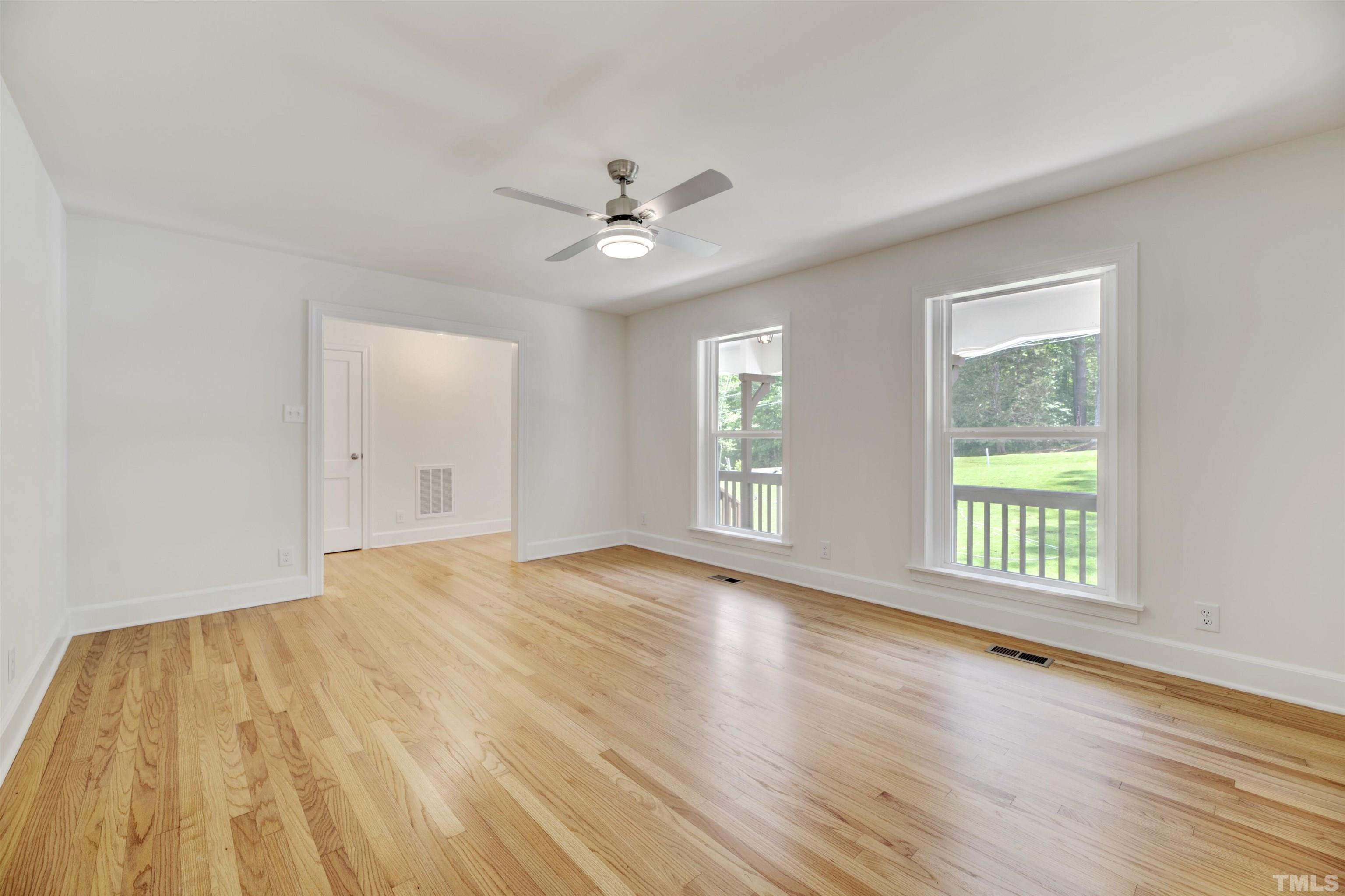 218 Hocutt Road Durham, NC 27703 - Photo 11 of 43 a view of an empty room with wooden floor and a window