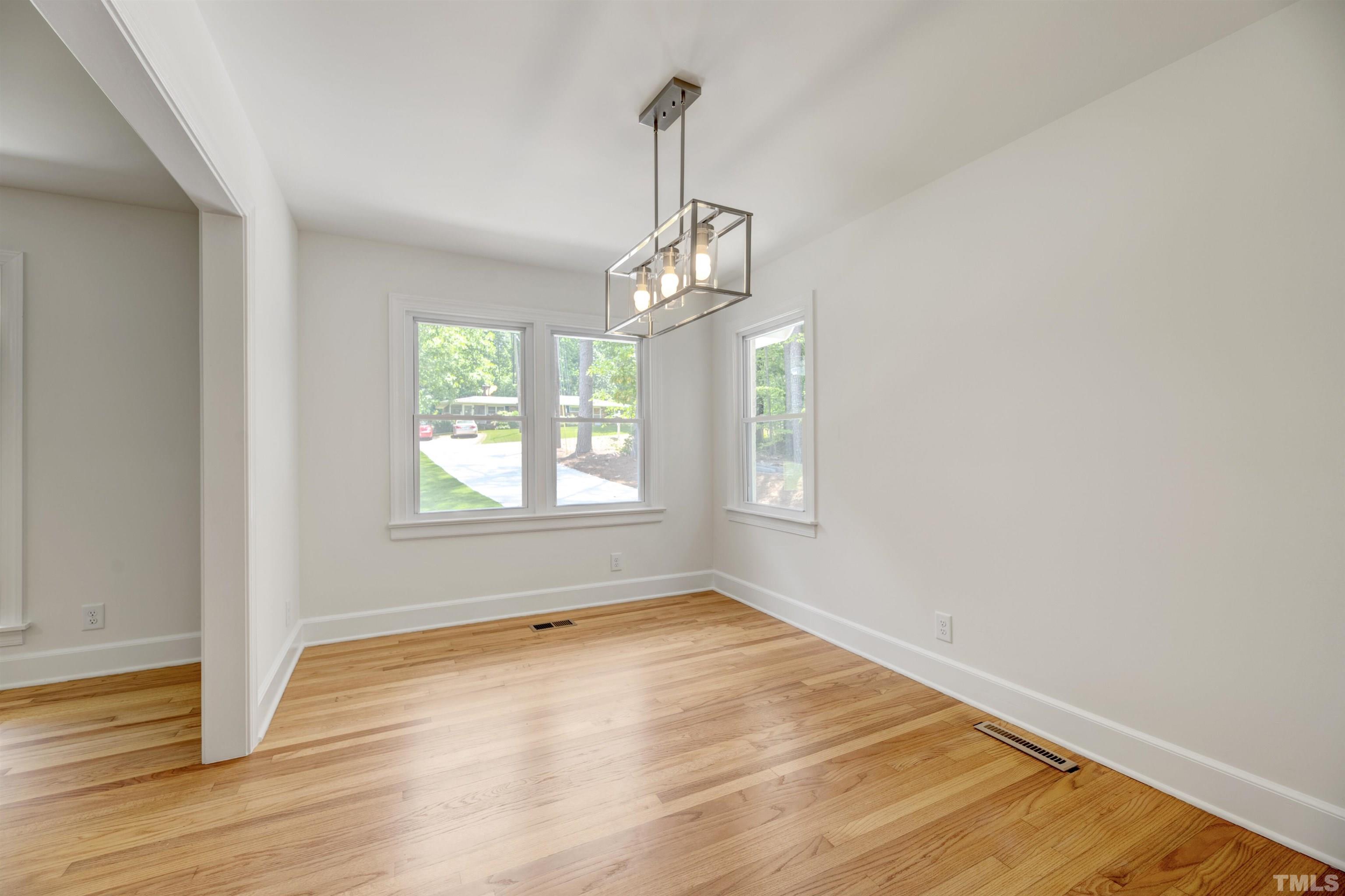 218 Hocutt Road Durham, NC 27703 - Photo 13 of 43 a view of empty room with wooden floor and fan