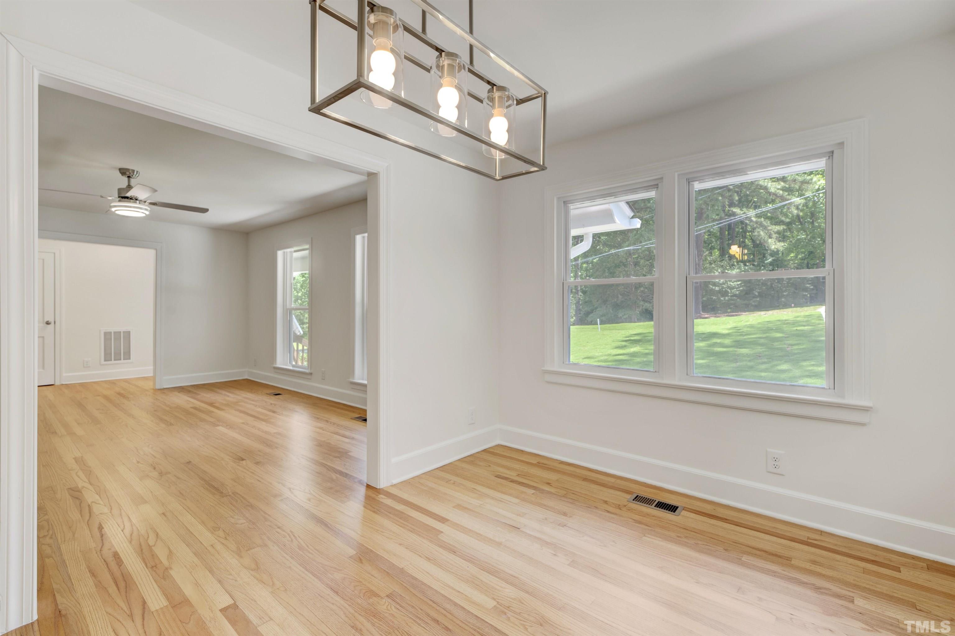 218 Hocutt Road Durham, NC 27703 - Photo 15 of 43 a view of empty room with wooden floor and fan