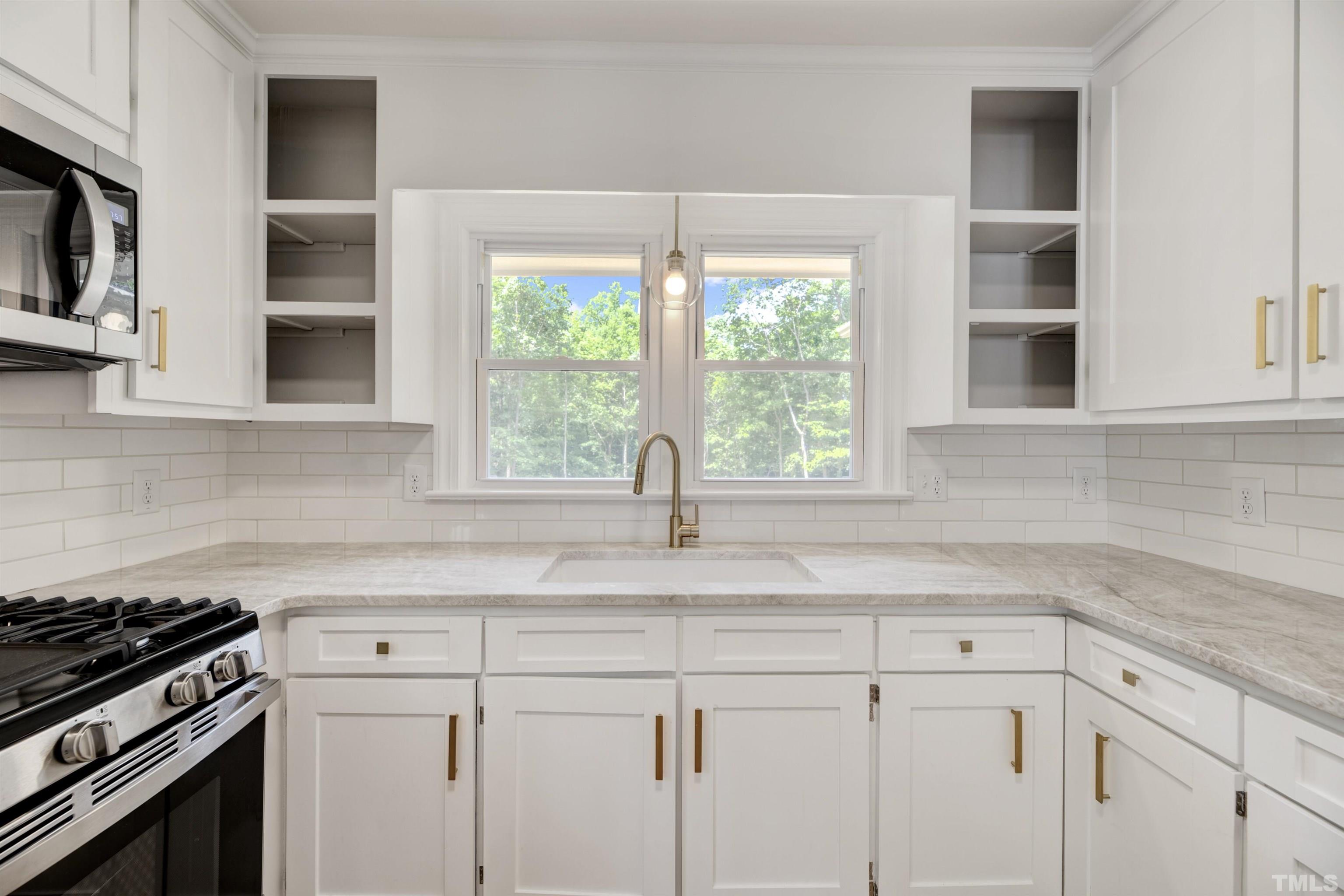 218 Hocutt Road Durham, NC 27703 - Photo 18 of 43 a kitchen with appliances cabinets and a window