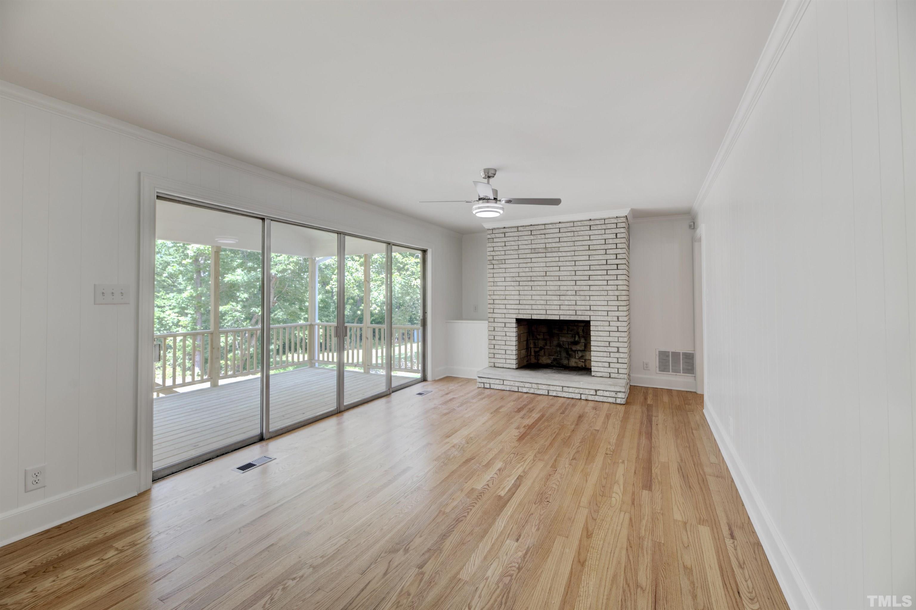 218 Hocutt Road Durham, NC 27703 - Photo 22 of 43 a view of an empty room with wooden floor and a window