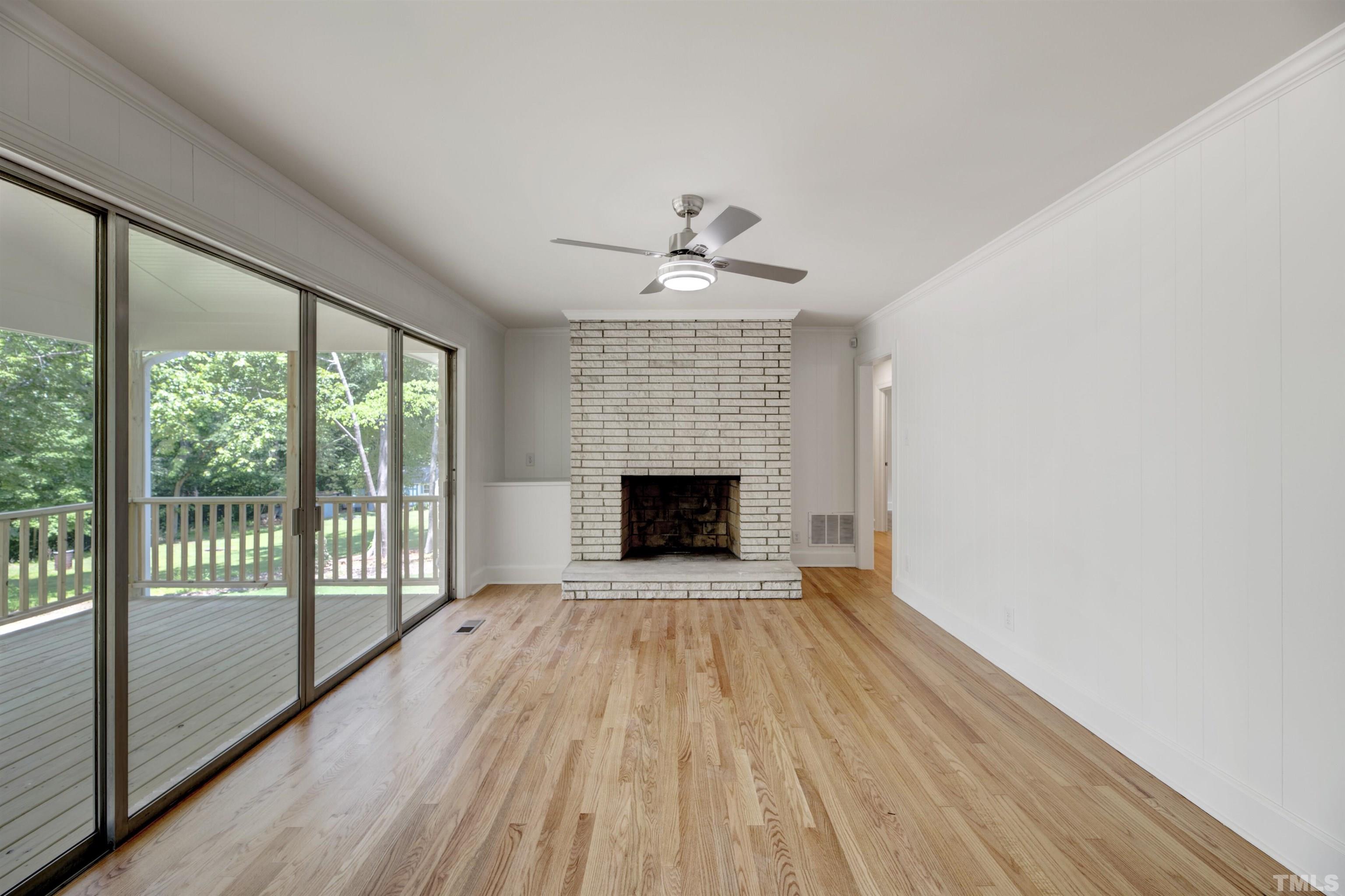 218 Hocutt Road Durham, NC 27703 - Photo 23 of 43 a view of an empty room with a fireplace and a window
