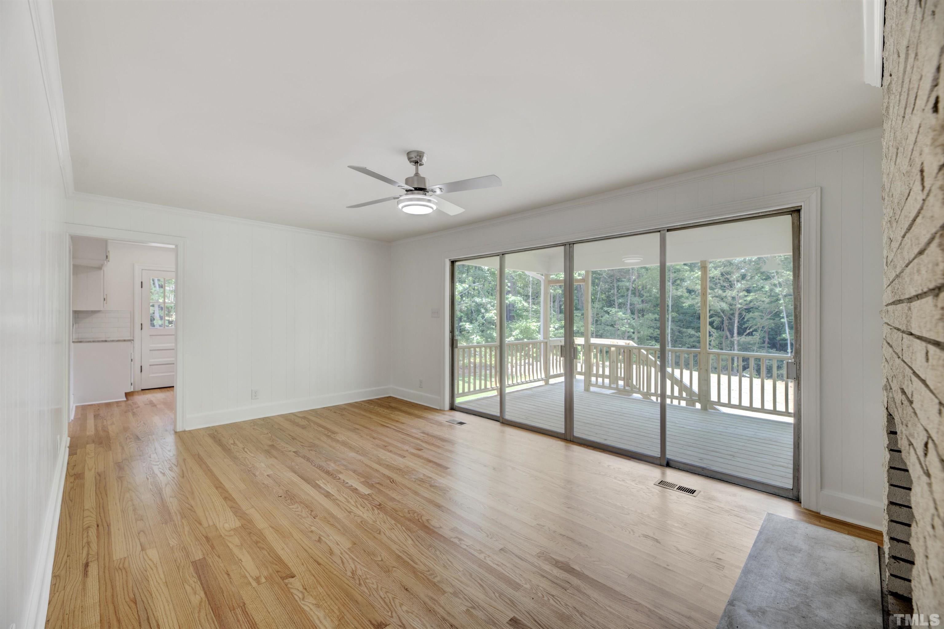 218 Hocutt Road Durham, NC 27703 - Photo 24 of 43 a view of an empty room with wooden floor and a window