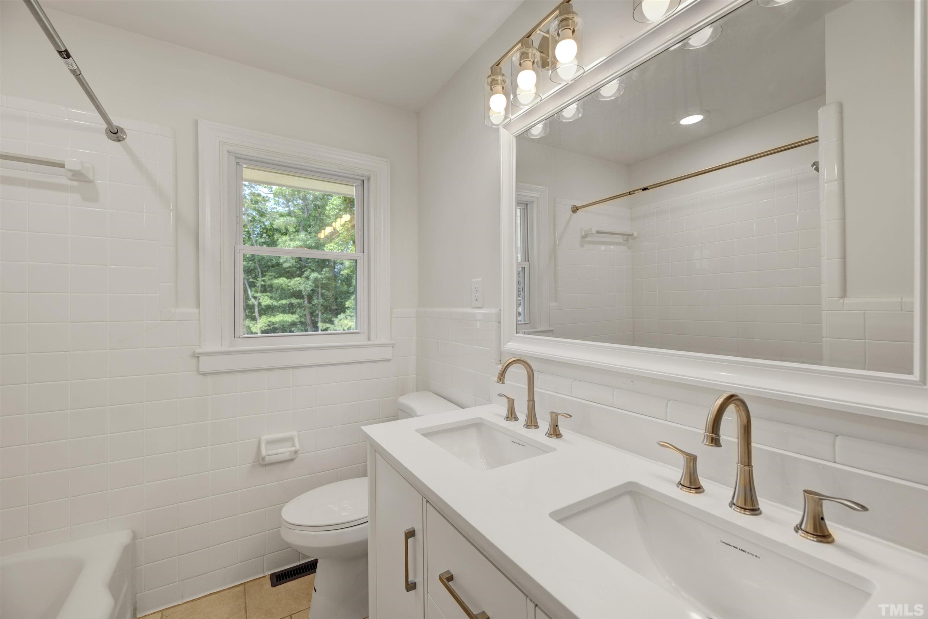 218 Hocutt Road Durham, NC 27703 - Photo 29 of 43 a bathroom with a sink toilet and a mirror