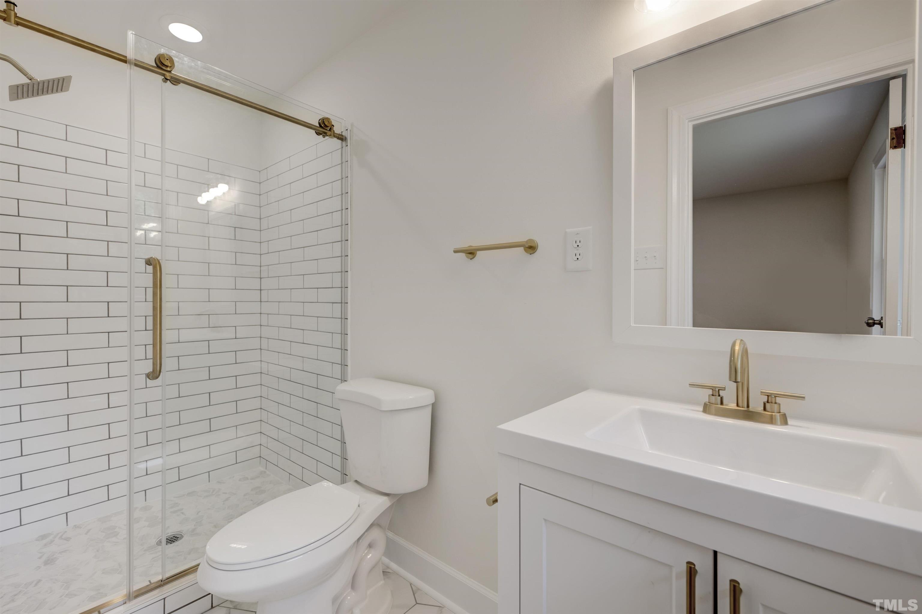218 Hocutt Road Durham, NC 27703 - Photo 36 of 43 a bathroom with a toilet sink vanity and mirror