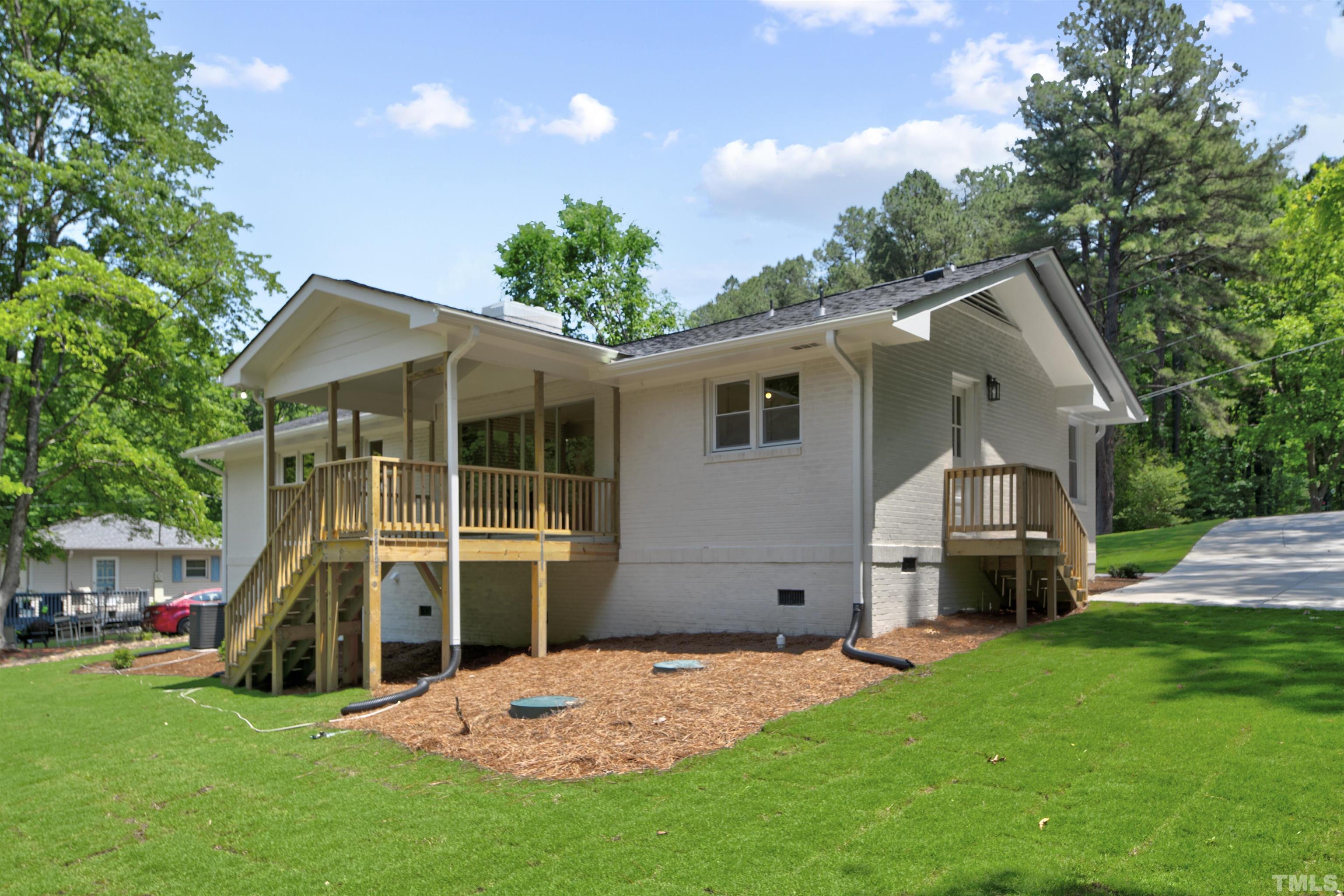 218 Hocutt Road Durham, NC 27703 - Photo 38 of 43 a front view of a house with a garden and trees