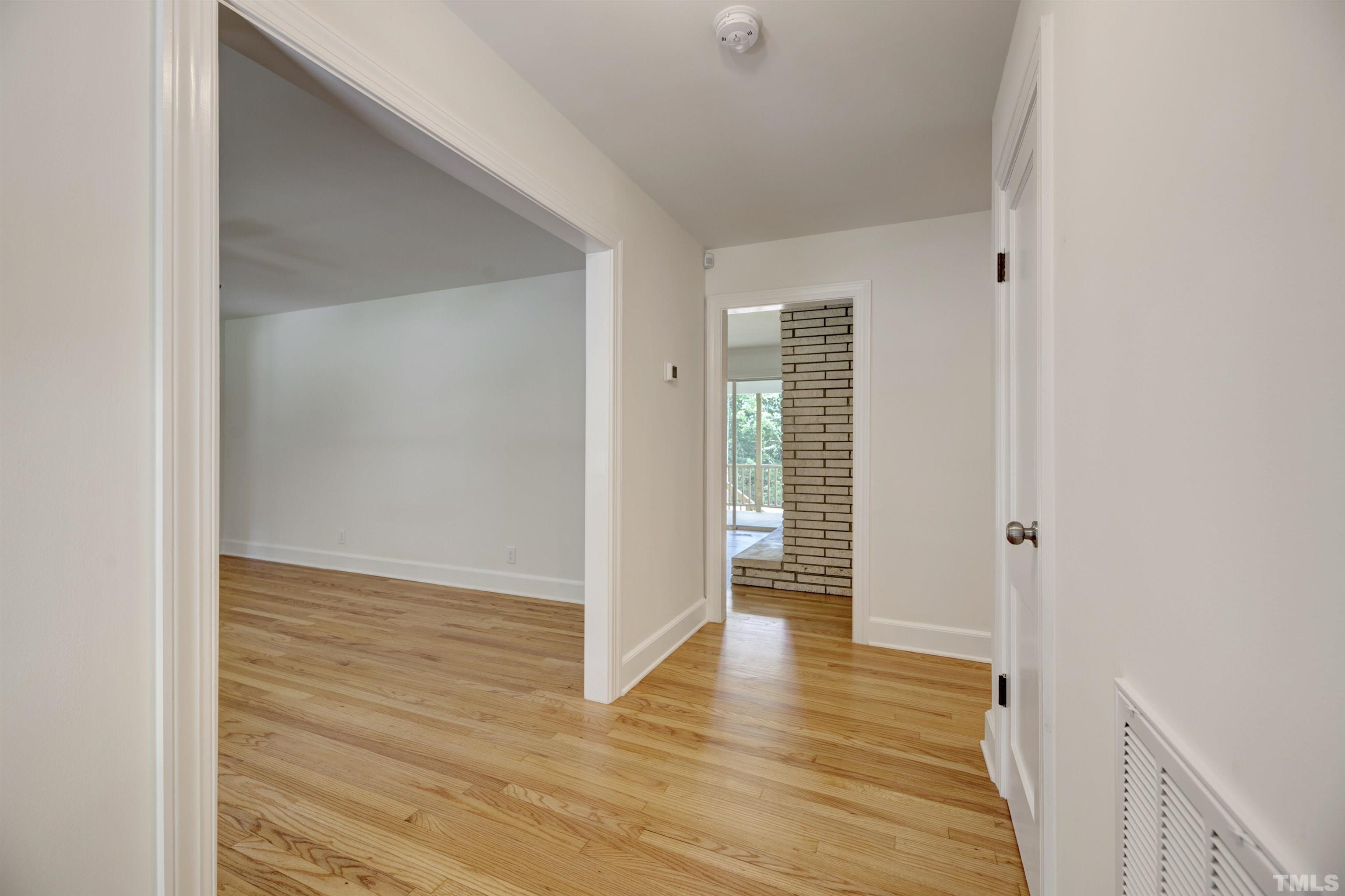 218 Hocutt Road Durham, NC 27703 - Photo 6 of 43 a view of hallway with wooden floor
