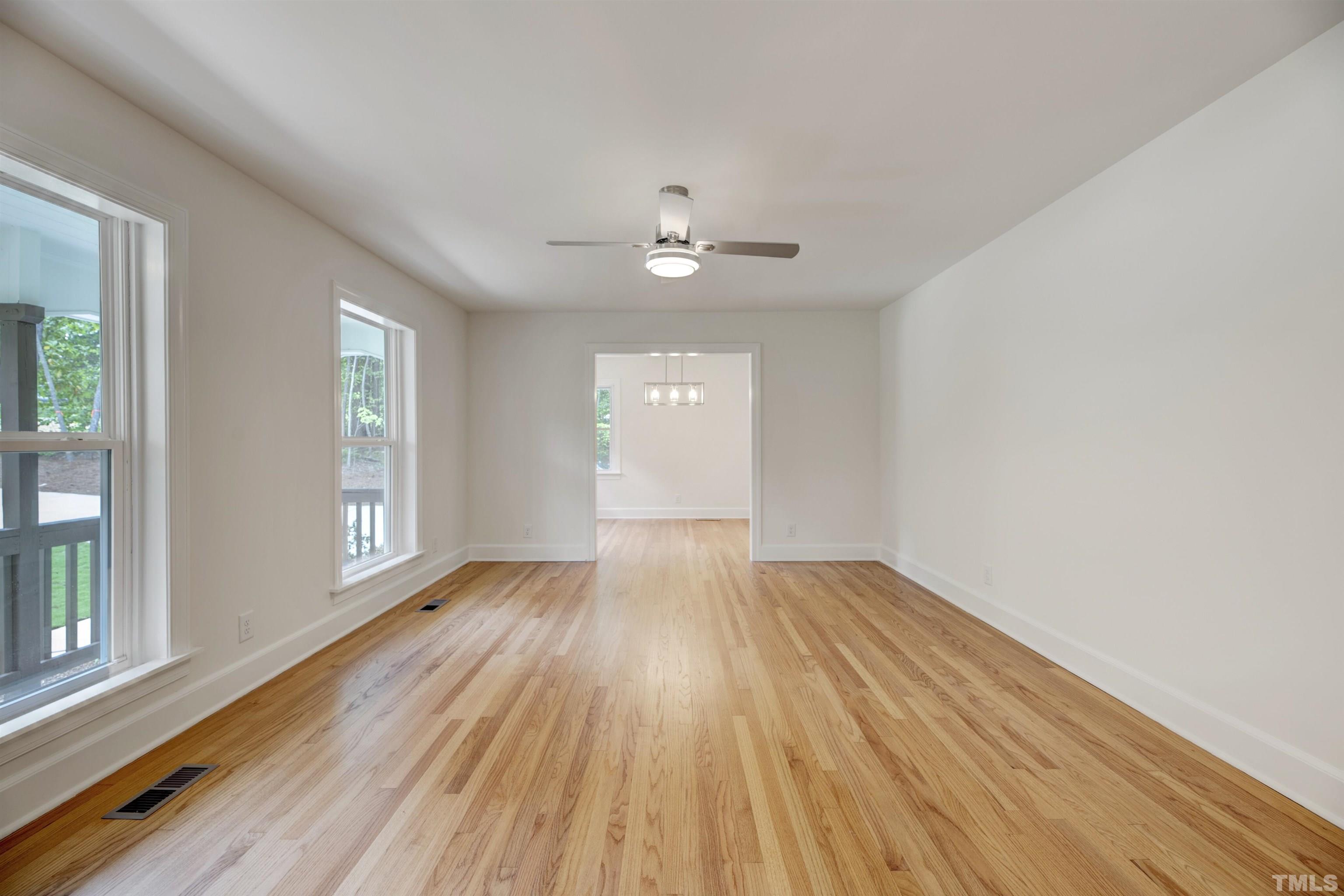 218 Hocutt Road Durham, NC 27703 - Photo 8 of 43 wooden floor in an empty room with a window