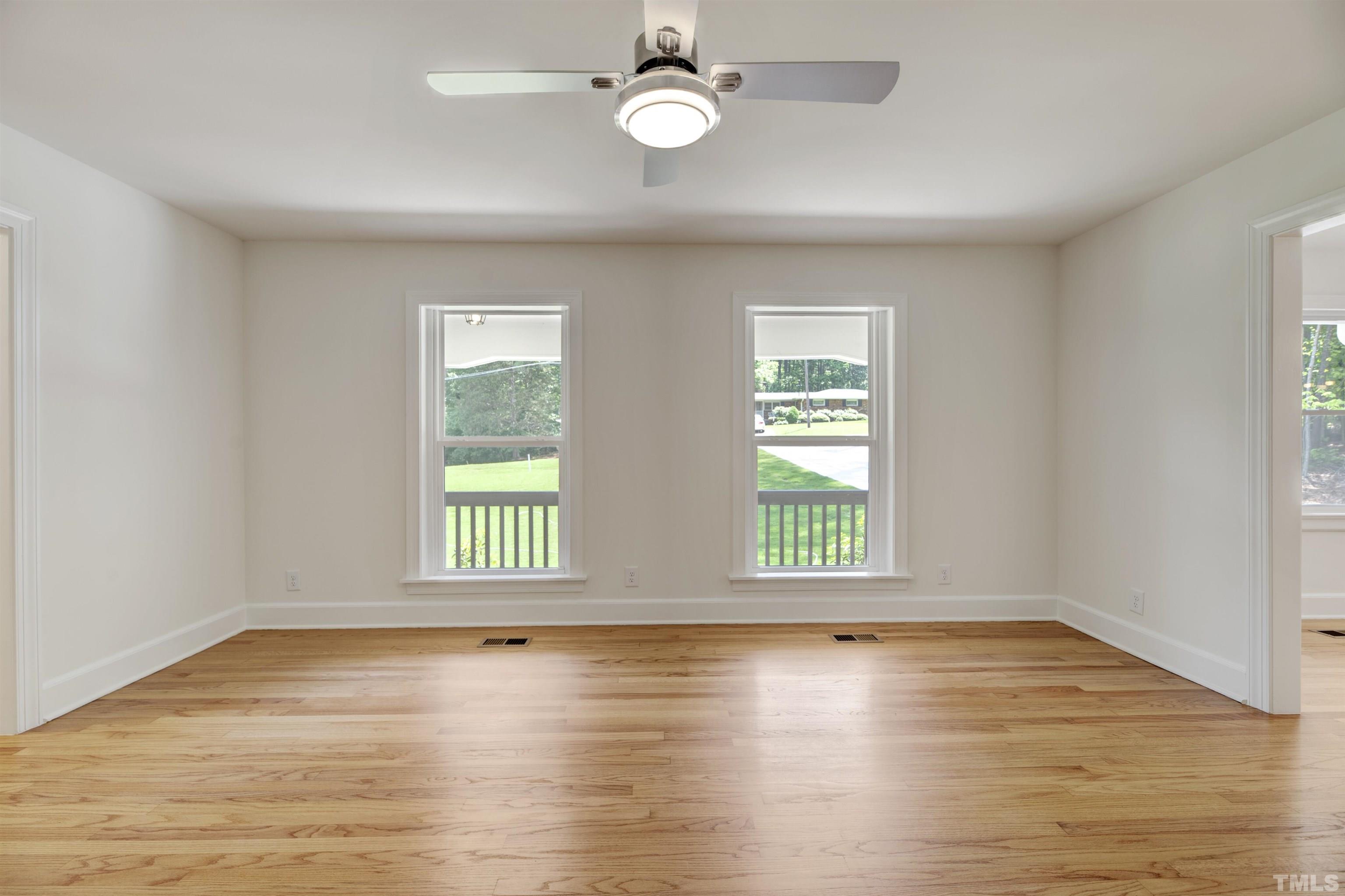 218 Hocutt Road Durham, NC 27703 - Photo 10 of 43 an empty room with wooden floor and windows
