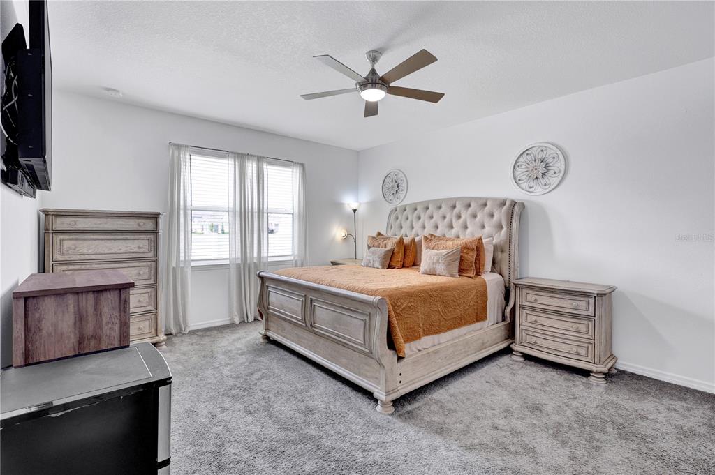 7185 Southwest 63rd Street Ocala, FL 34474 - Photo 17 of 31 a bedroom with a bed and a television