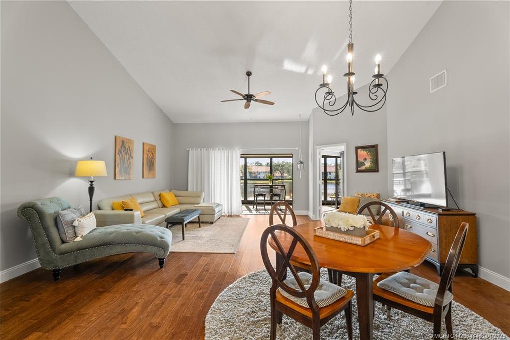 6130 Southeast Martinique Drive, Unit 201 Stuart, FL 34997 - Photo 11 of 36 a living room with furniture kitchen view and a window