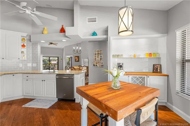 a kitchen with stainless steel appliances a refrigerator a sink and a stove