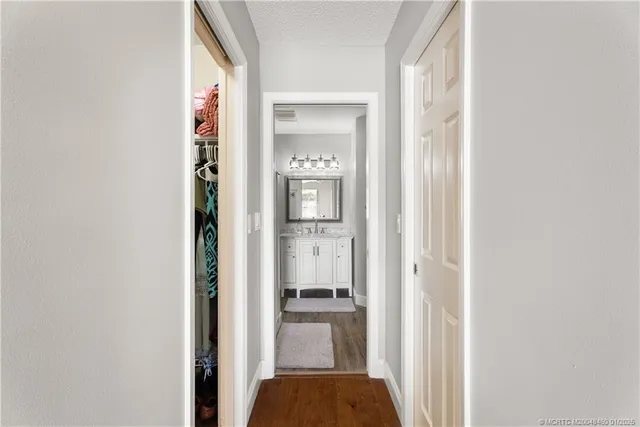 a bathroom with a granite countertop sink a mirror and shower
