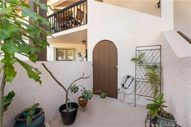 a view of a porch with wooden floor and furniture