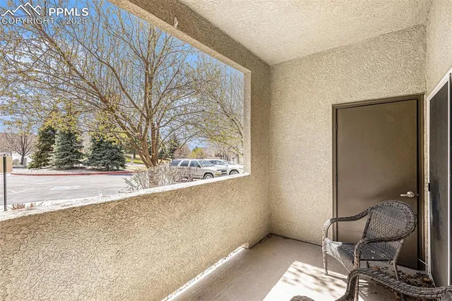 a view of a room that has a bench and chair in it