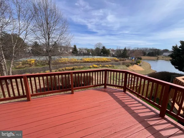 a balcony with wooden floor and city view