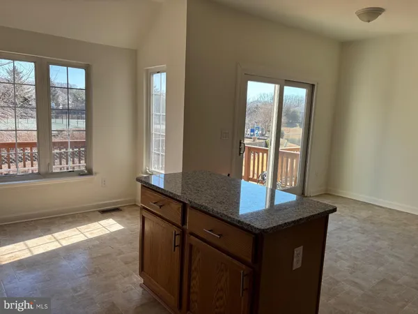 a kitchen with granite countertop cabinets and window