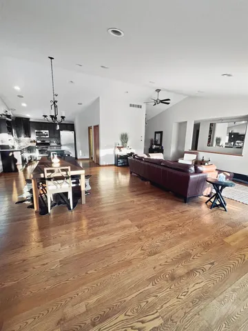 a living room with lots of furniture and kitchen view