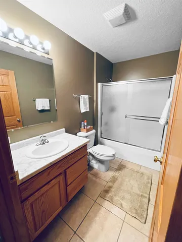 a bedroom with a bed and a large mirror