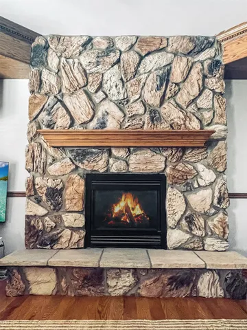 a living room with a fireplace and a fireplace