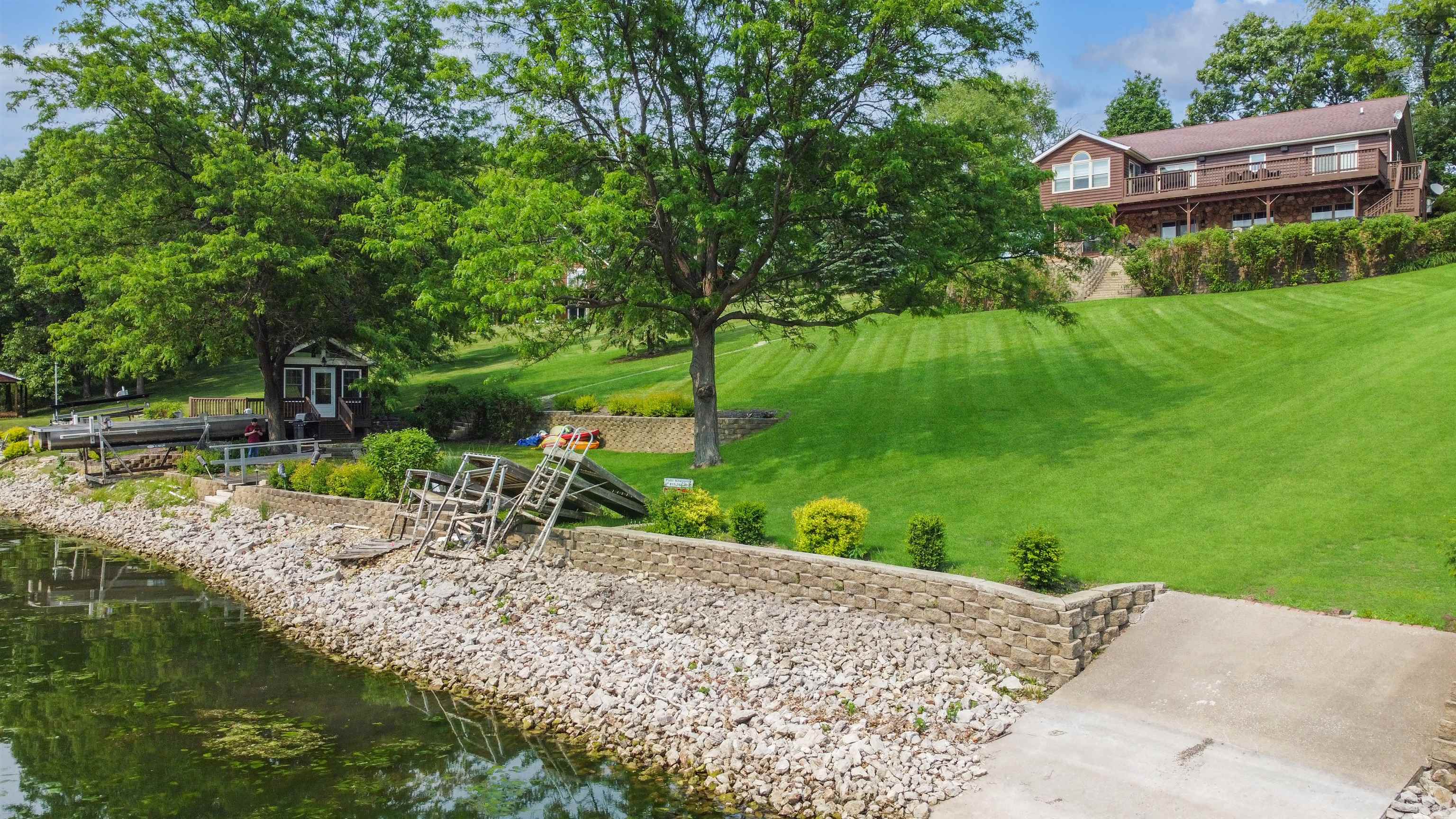 27-54 Ridgeview Drive Lake Carroll, IL 61046 - Photo 42 of 58 a view of a backyard with a garden and swimming pool