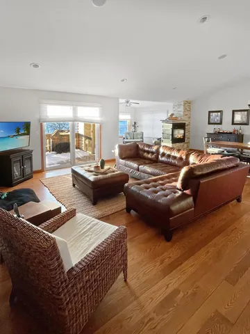 a living room with furniture kitchen view and a fireplace