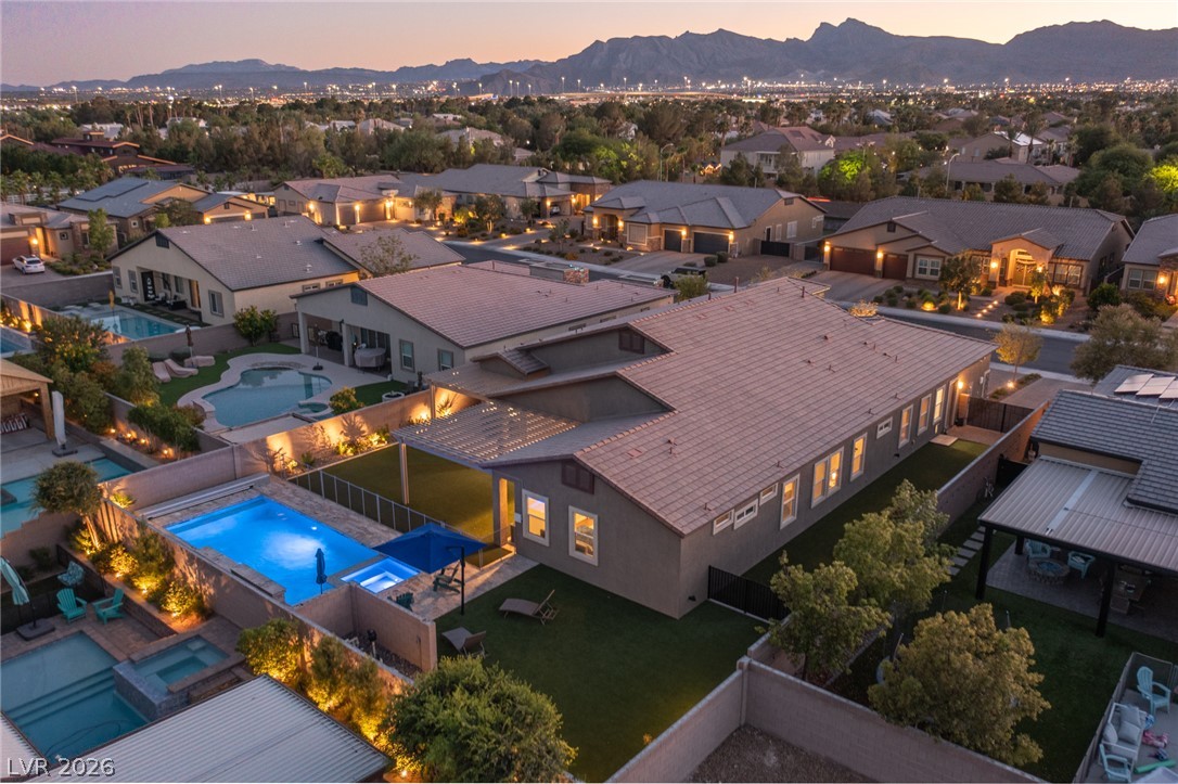 7036 Arabian Ridge Street Las Vegas, NV 89131 - Photo 5 of 64 Single Story Stunner with sparkling pool, spa, and permanent exterior lighting allowing you to customize colors, patterns, and schedules for holidays, game days, or everyday ambiance.