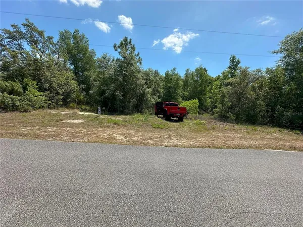 a view of a porch with furniture and a yard