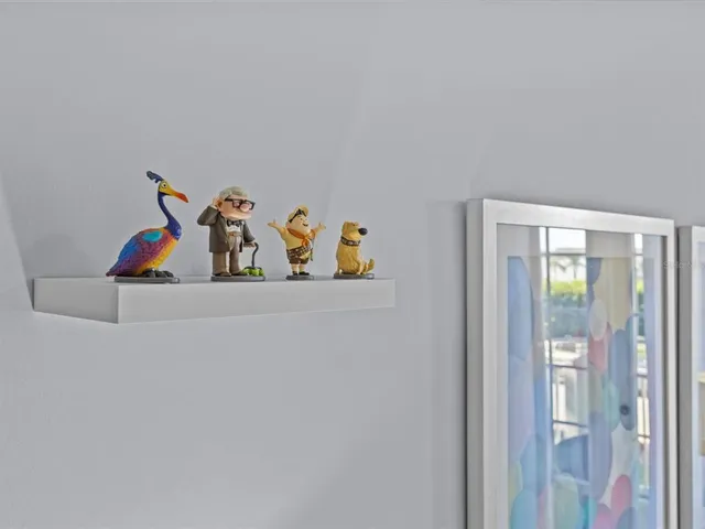 a view of a hallway with two painting on the wall