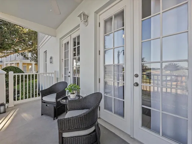 a living room with furniture and a floor to ceiling window