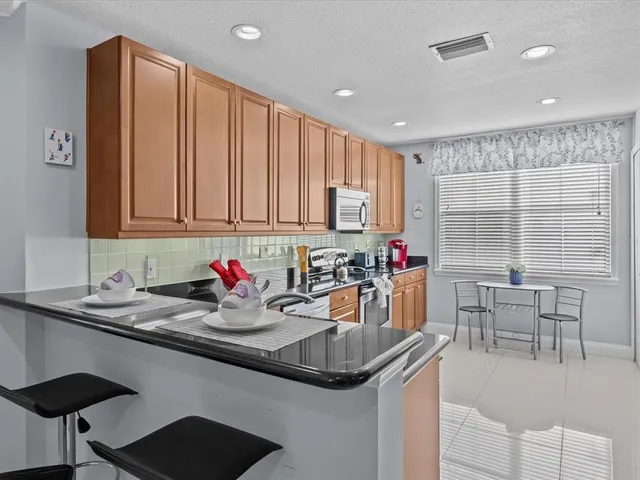 a kitchen with stainless steel appliances granite countertop a sink and cabinets