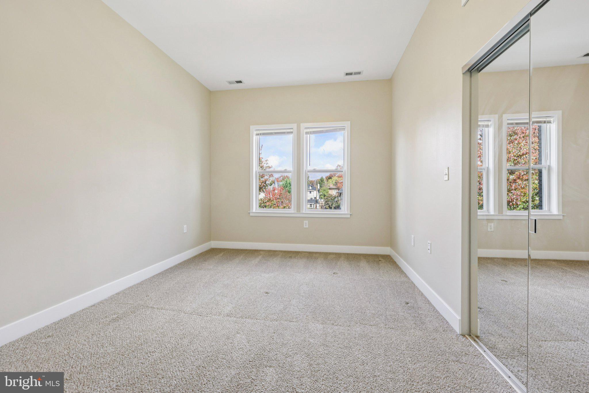1352 Longfellow Street Northwest, Unit 302 Washington, DC 20011 - Photo 13 of 24 an empty room with windows