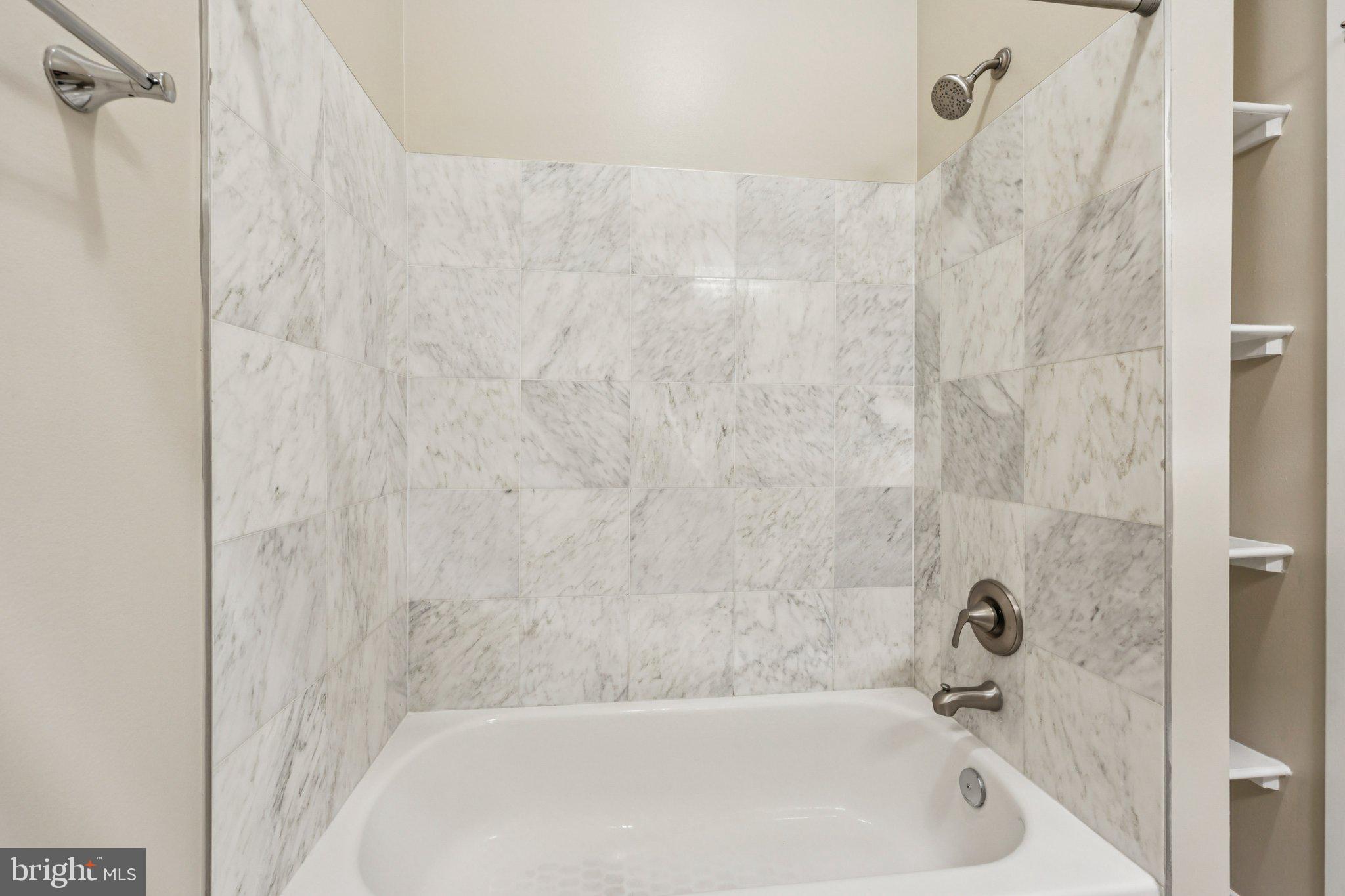 1352 Longfellow Street Northwest, Unit 302 Washington, DC 20011 - Photo 17 of 24 a bathroom with a bathtub