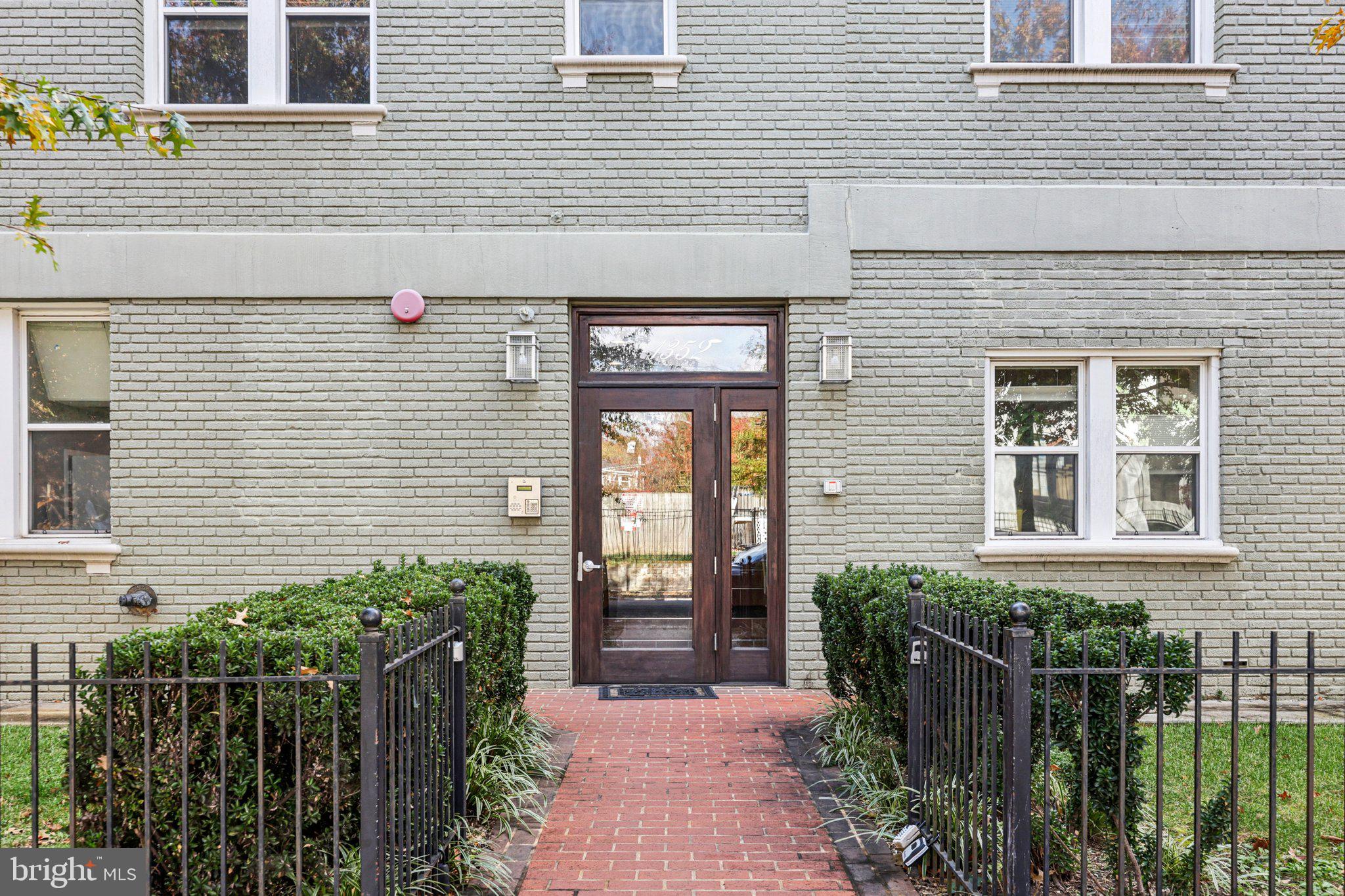 1352 Longfellow Street Northwest, Unit 302 Washington, DC 20011 - Photo 2 of 24 a front view of a house with a porch