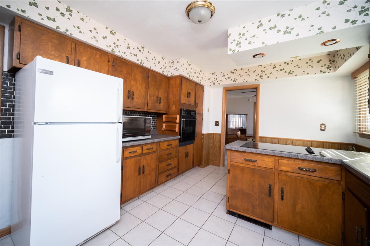 4228 Pinecrest Road Rockford, IL 61107 - Photo 11 of 30 a kitchen with stainless steel appliances granite countertop a refrigerator and a stove top oven
