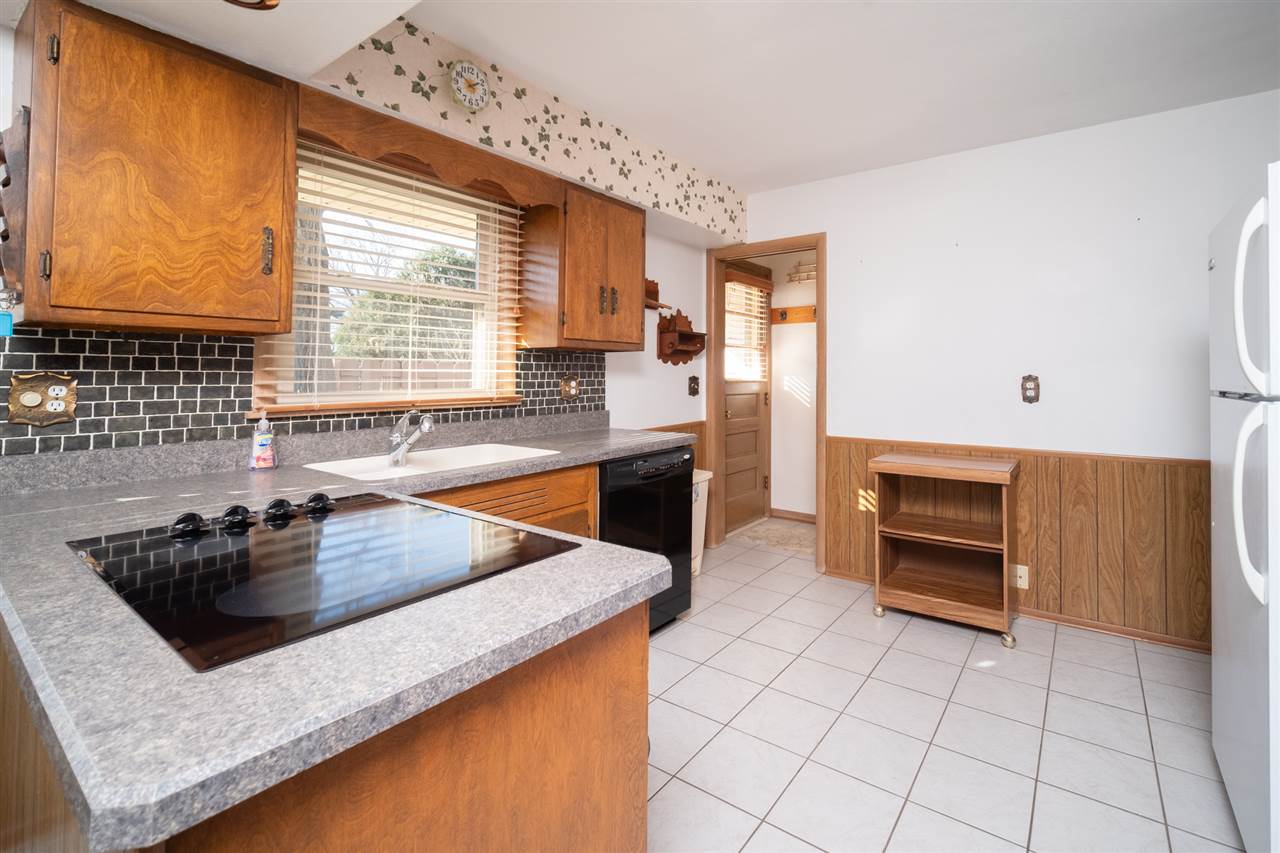 4228 Pinecrest Road Rockford, IL 61107 - Photo 13 of 30 a kitchen with granite countertop a sink and a stove top oven