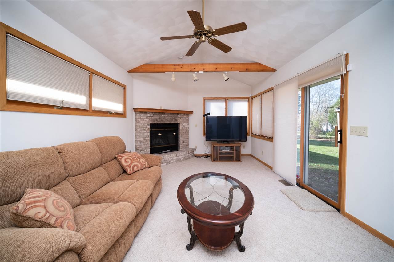 4228 Pinecrest Road Rockford, IL 61107 - Photo 15 of 30 a living room with furniture a flat screen tv and a fireplace