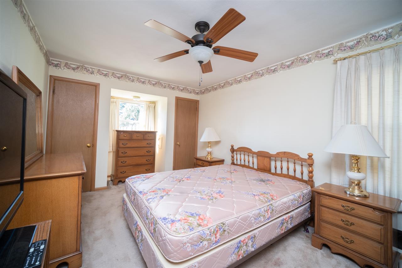 4228 Pinecrest Road Rockford, IL 61107 - Photo 17 of 30 a bedroom with a bed and a chandelier