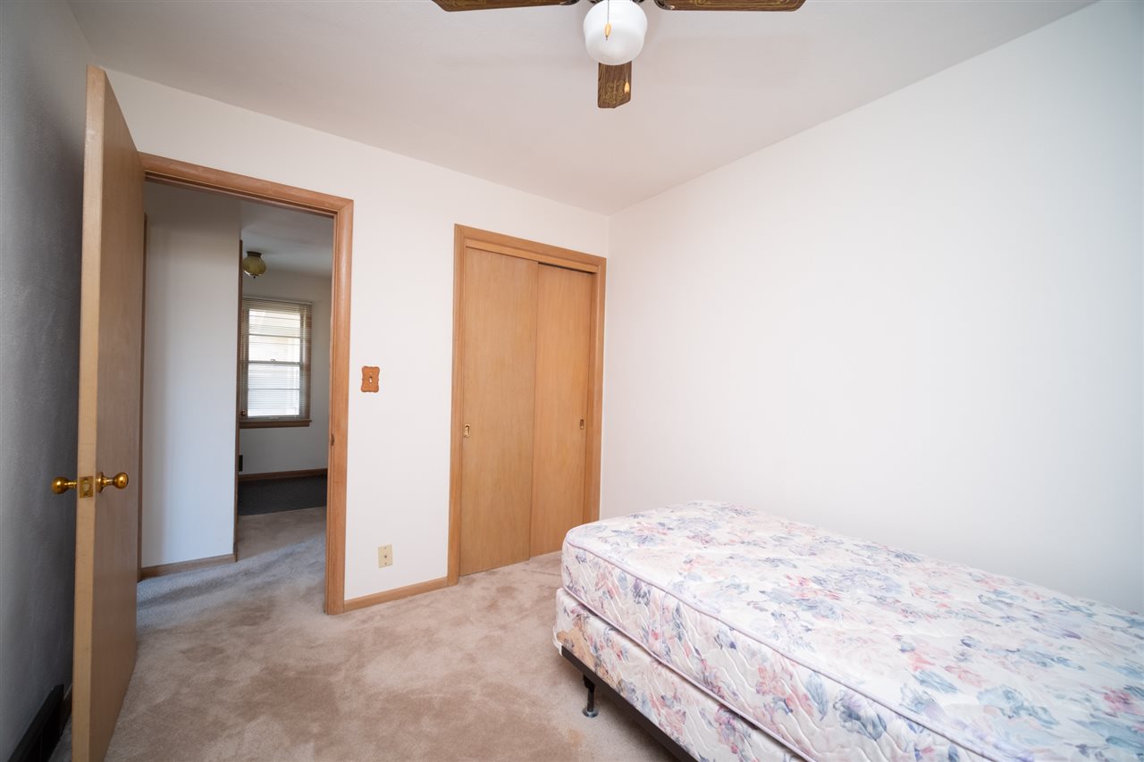 4228 Pinecrest Road Rockford, IL 61107 - Photo 21 of 30 a bedroom with a bed and a chandelier fan