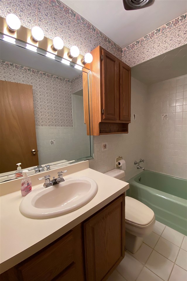 4228 Pinecrest Road Rockford, IL 61107 - Photo 22 of 30 a bathroom with a sink a toilet and tub