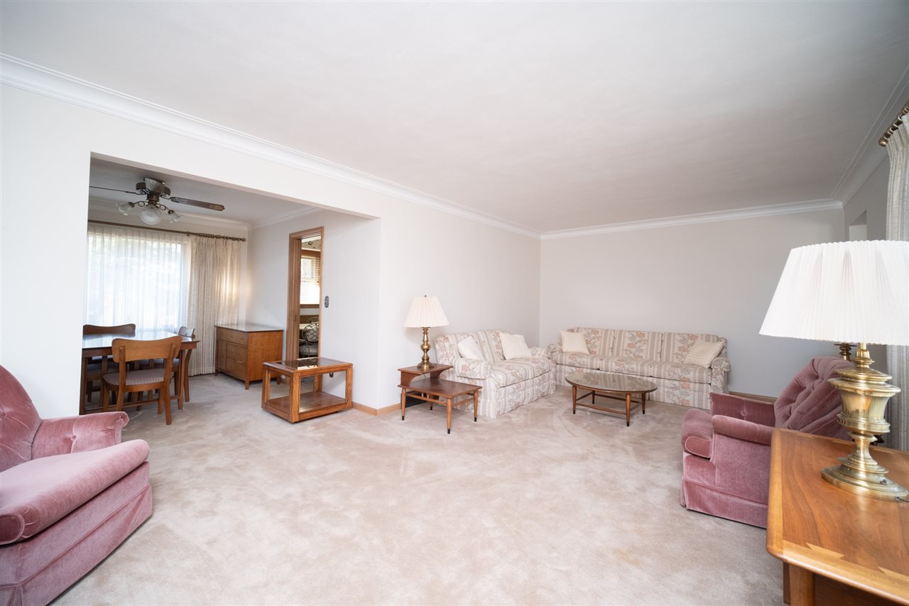 4228 Pinecrest Road Rockford, IL 61107 - Photo 8 of 30 a living room with furniture and a lamp