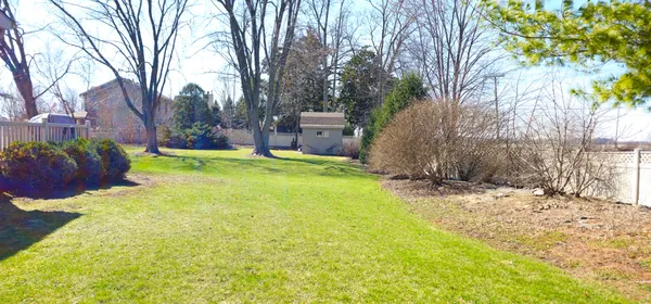a view of a hallway with wooden floor and windows