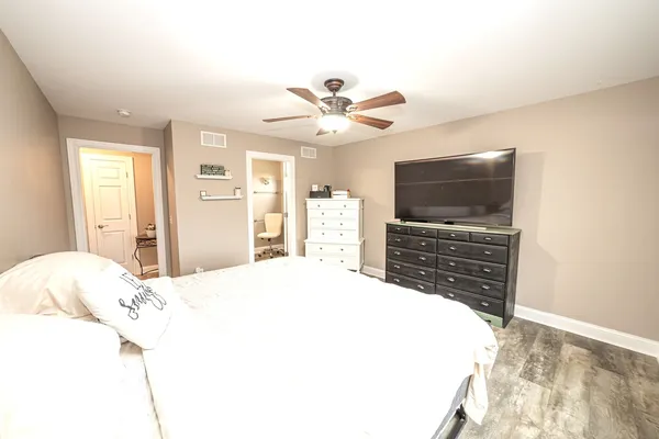 a bedroom with a bed and a chandelier