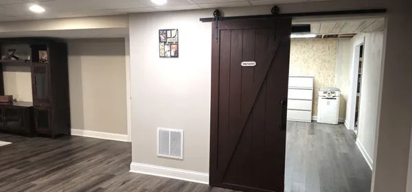 a view of a hallway with wooden walls and stairs