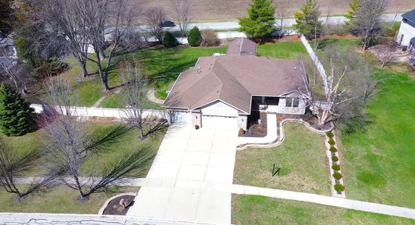 an aerial view of a house with garden space and street view