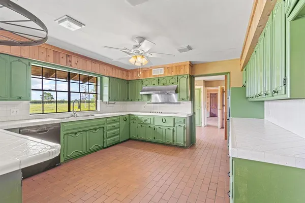 a kitchen with lots of counter top space and a sink