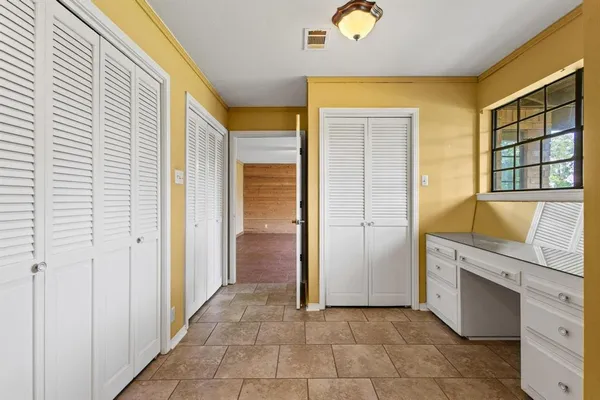 a view of an empty room with a fireplace and a window