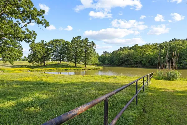 a view of a swimming pool with a lawn chairs under an umbrella