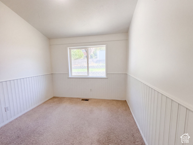 232 Bugle Way Providence, UT 84332 - Photo 15 of 36 Light-colored carpeting, white wainscoting, and a window with a white frame